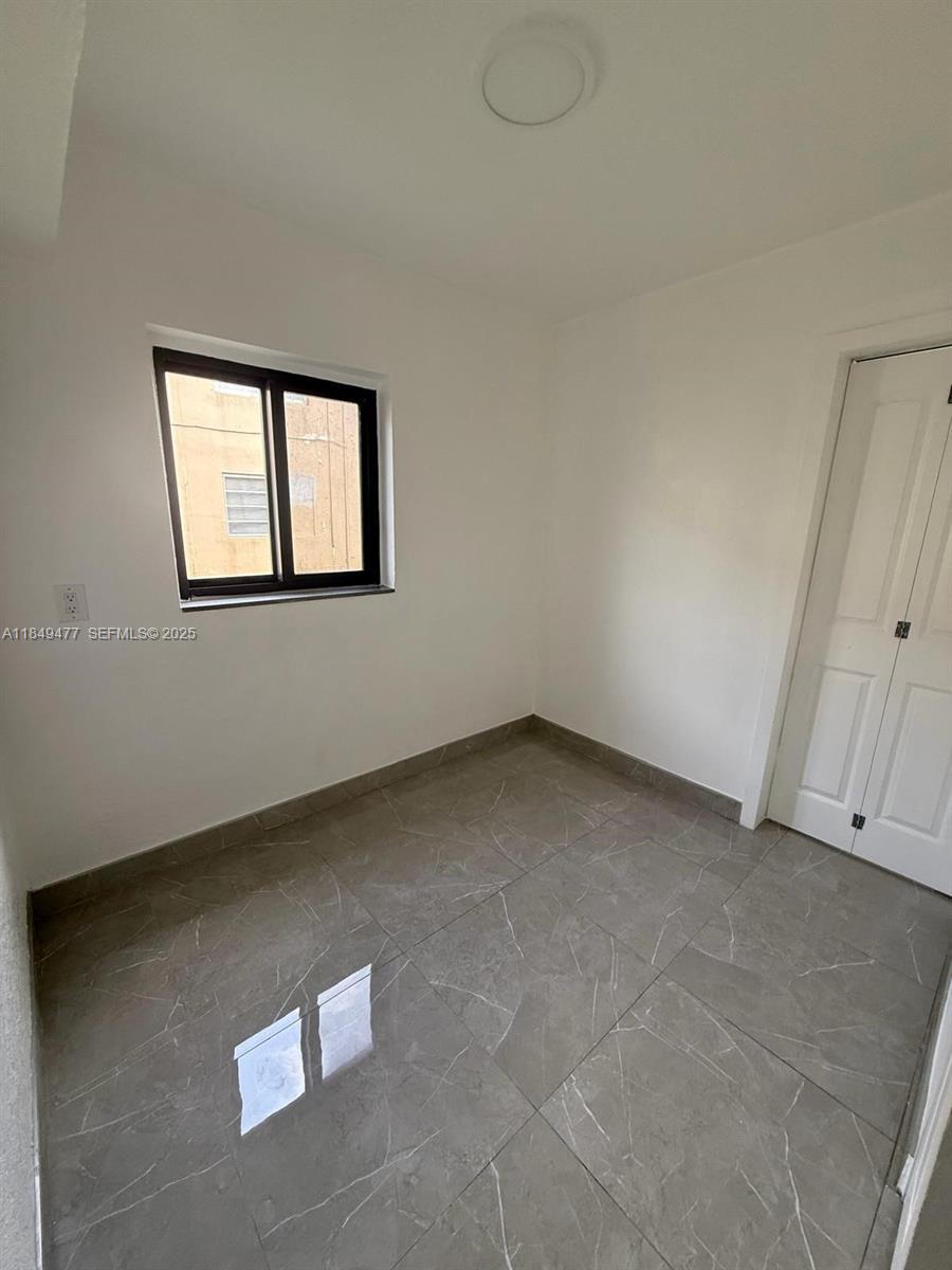 351 East 4th Avenue, Unit 4 Hialeah, FL 33010 - Photo 6 of 19 an empty room with a window
