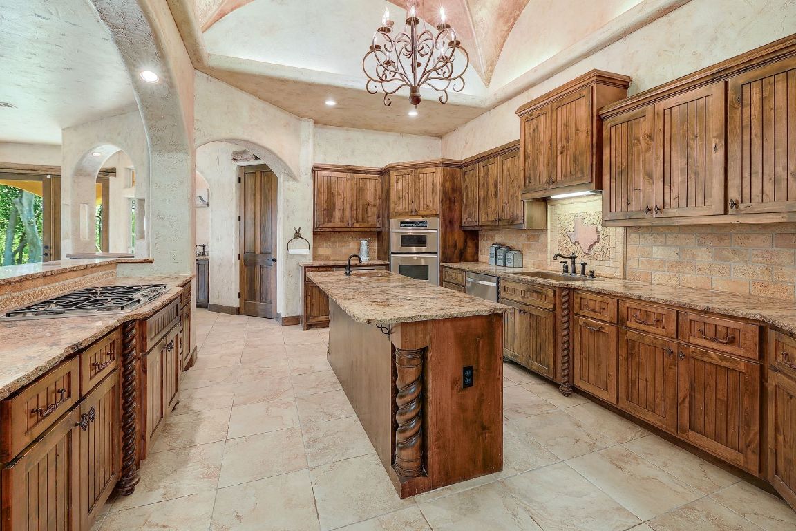 1120 Redbird Road Granger, TX 76530 - Photo 13 of 40 a kitchen with a sink stove and cabinets