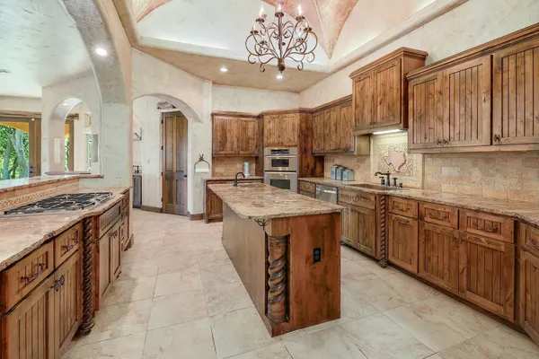 a kitchen with a sink stove and cabinets