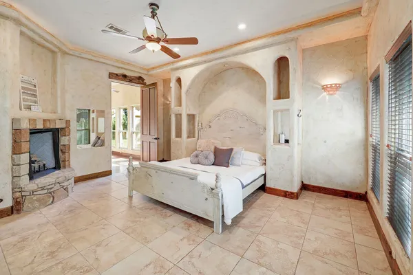 a spacious bedroom with a bed and a fireplace