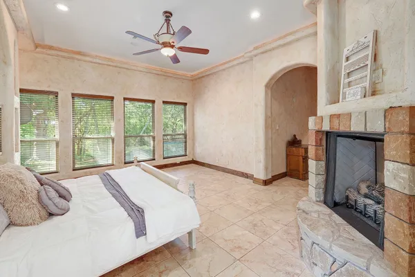 a spacious bedroom with a bed and a large window