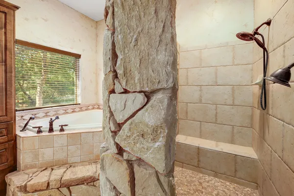 a bathroom with a bathtub and window