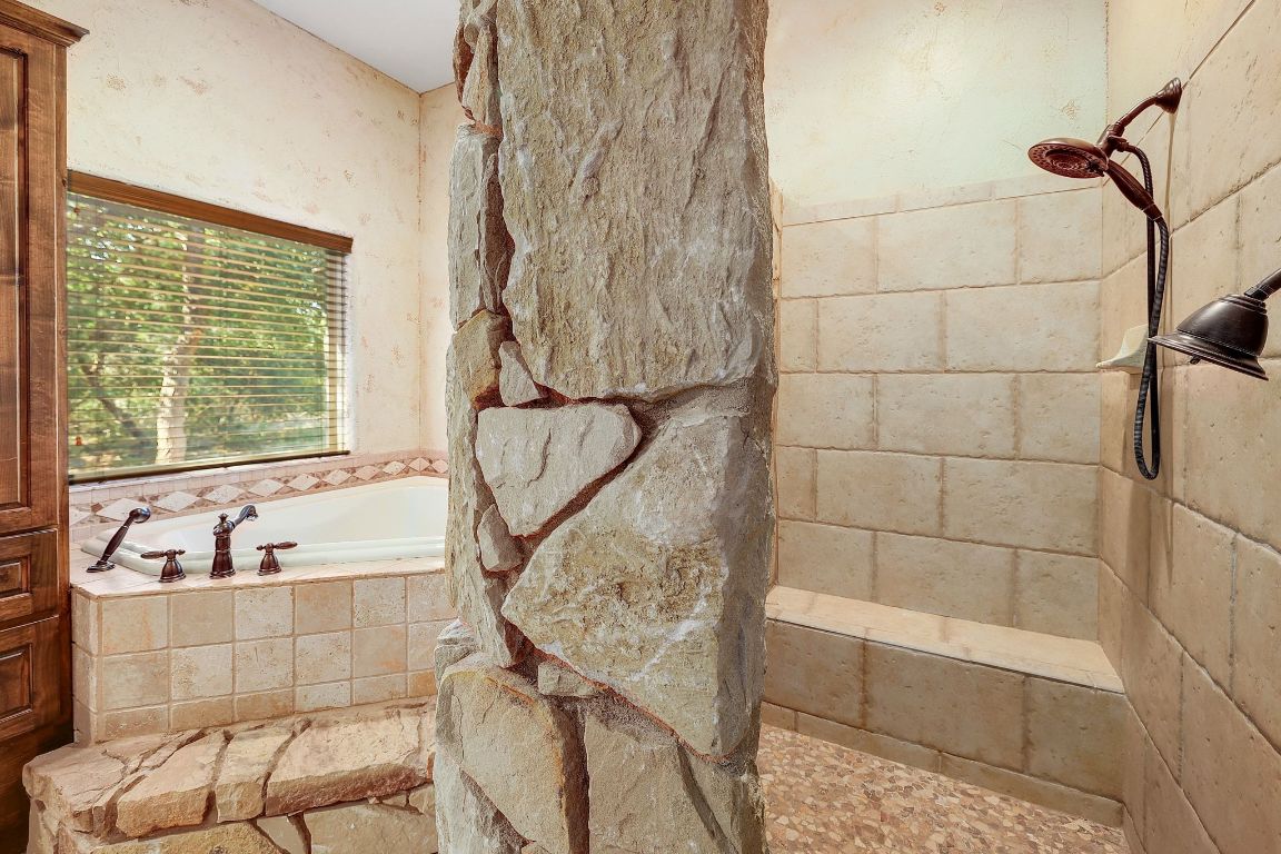 1120 Redbird Road Granger, TX 76530 - Photo 21 of 40 a bathroom with a bathtub and window