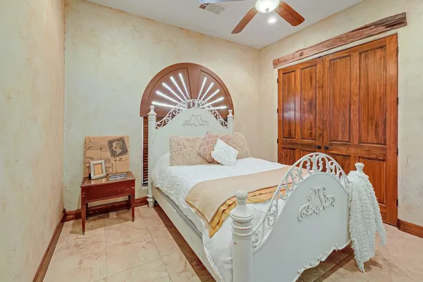 a bedroom with a bed and a painting on the wall