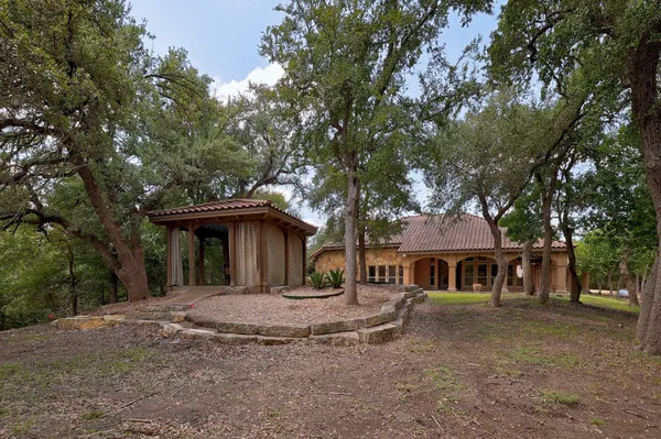 a view of house with a trees in front of it