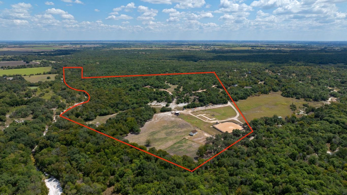 1120 Redbird Road Granger, TX 76530 - Photo 3 of 40 an aerial view of a house with a garden and lake view