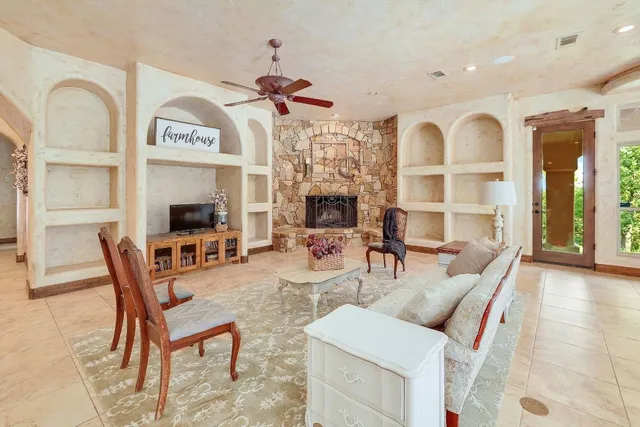 a living room with furniture a chandelier and a large window