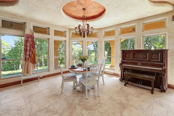 a living room with furniture a table and a large window