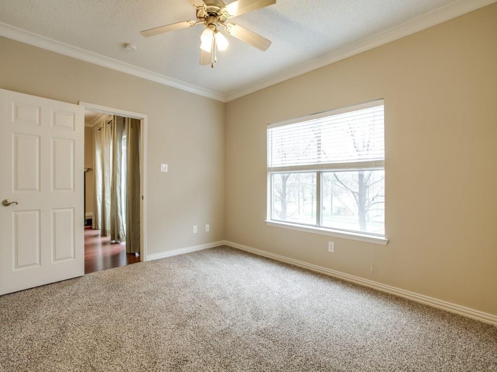 2201 Wolf Street, Unit 6104 Dallas, TX 75201 - Photo 3 of 11 an empty room with windows and chandelier fan