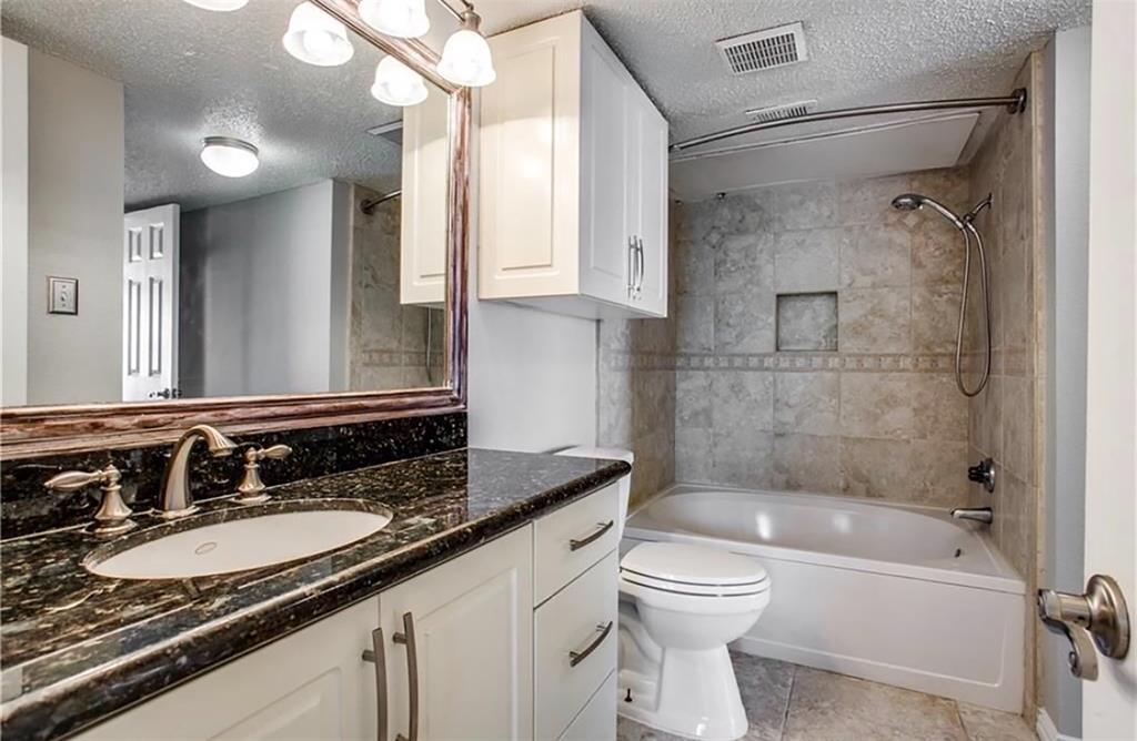 2201 Wolf Street, Unit 6104 Dallas, TX 75201 - Photo 4 of 11 a bathroom with a granite countertop sink toilet and shower