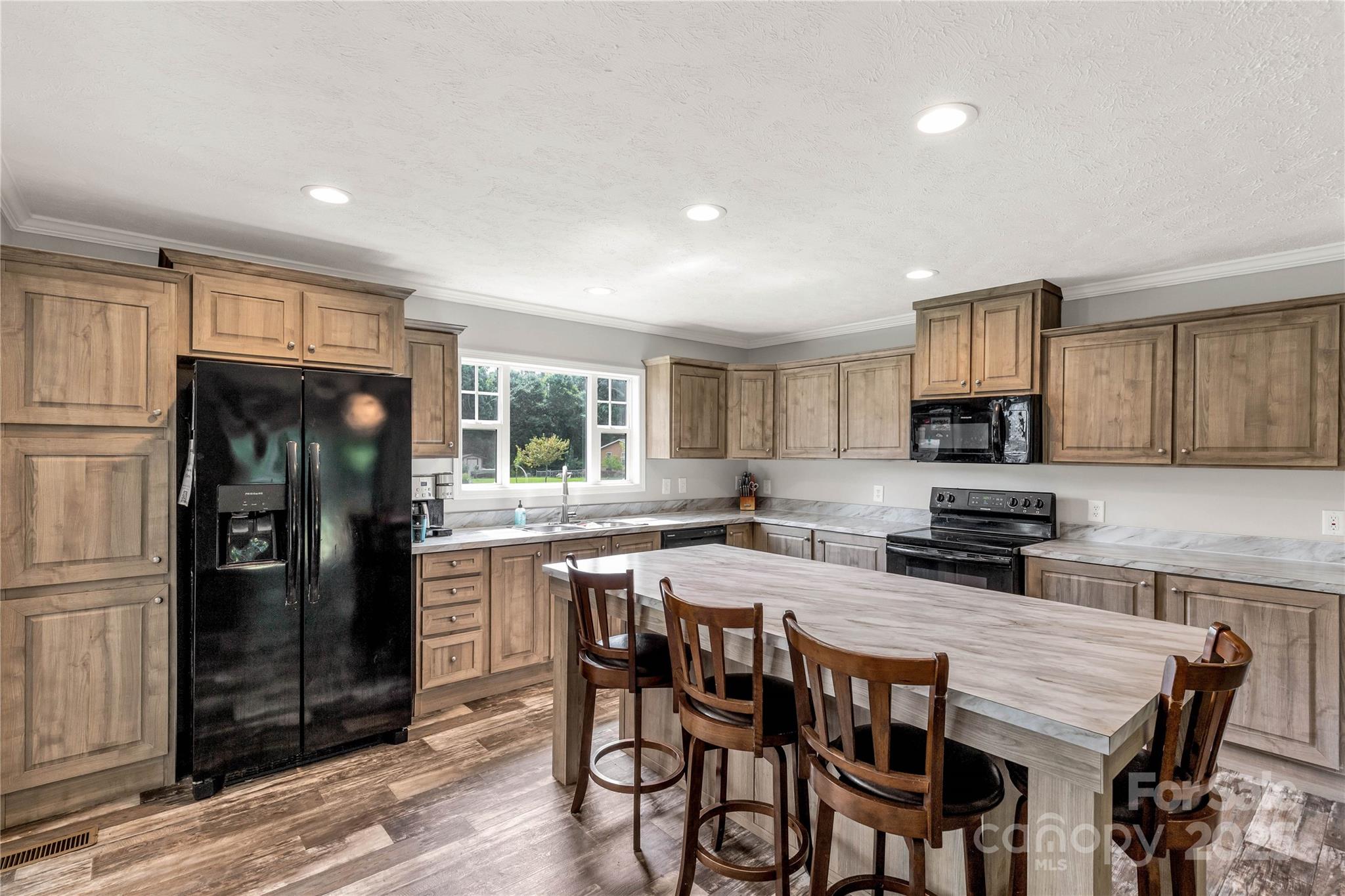 159 Blackmon Road Lancaster, SC 29720 - Photo 13 of 32 a kitchen with stainless steel appliances granite countertop a stove a refrigerator a sink a dining table and chairs