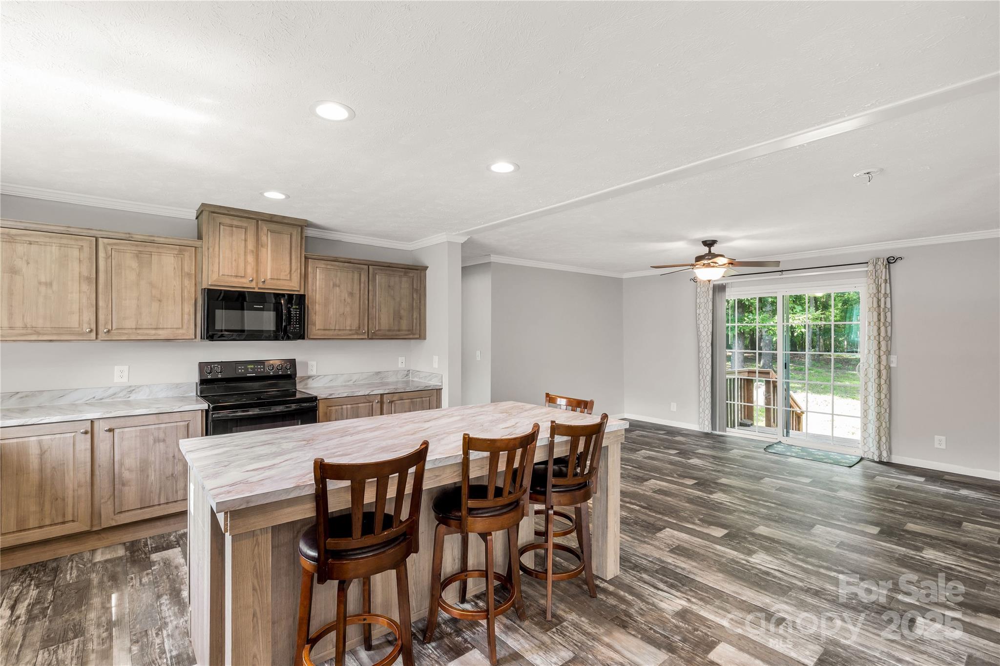 159 Blackmon Road Lancaster, SC 29720 - Photo 8 of 32 a kitchen with granite countertop a dining table chairs and wooden floor
