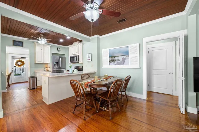 a view of a dining room with furniture and wooden floor