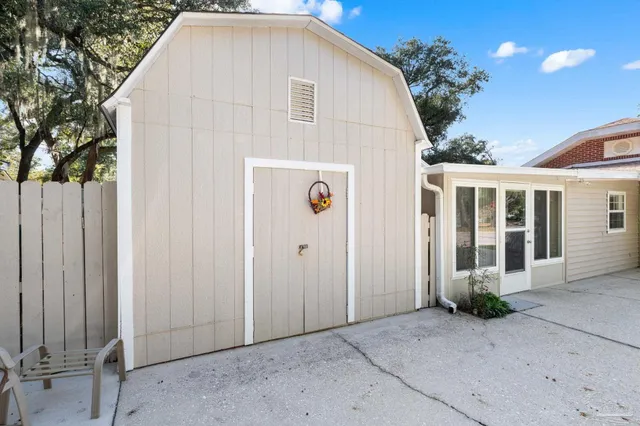an aerial view of a house with a yard and large trees