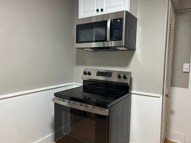 a kitchen with a stove and microwave
