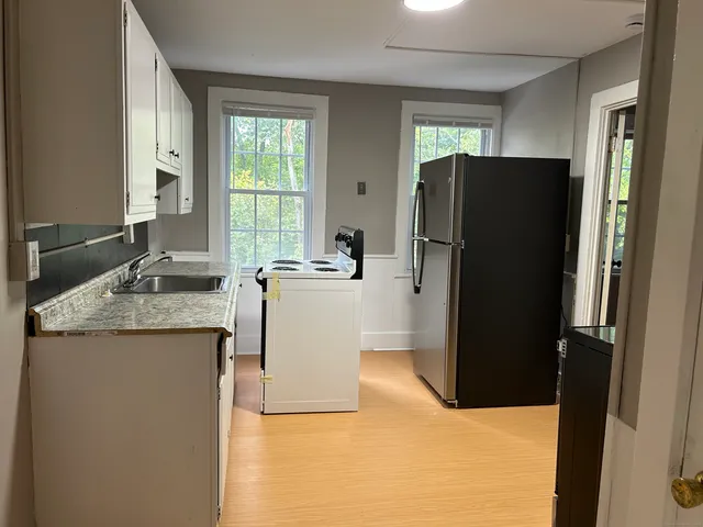 a kitchen with a refrigerator and a sink