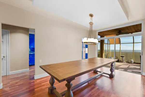 a view of a room with furniture and wooden floor