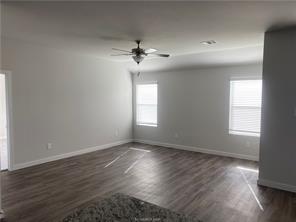 6022 Eagle Ridge Drive Bryan, TX 77807 - Photo 3 of 11 an empty room with wooden floor ceiling fan and windows