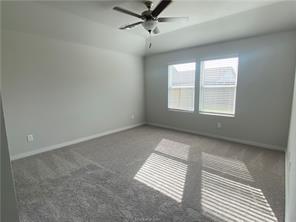 6022 Eagle Ridge Drive Bryan, TX 77807 - Photo 6 of 11 an empty room with windows and fan