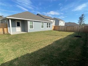 6022 Eagle Ridge Drive Bryan, TX 77807 - Photo 10 of 11 a view of a yard in front of a house with a large tree