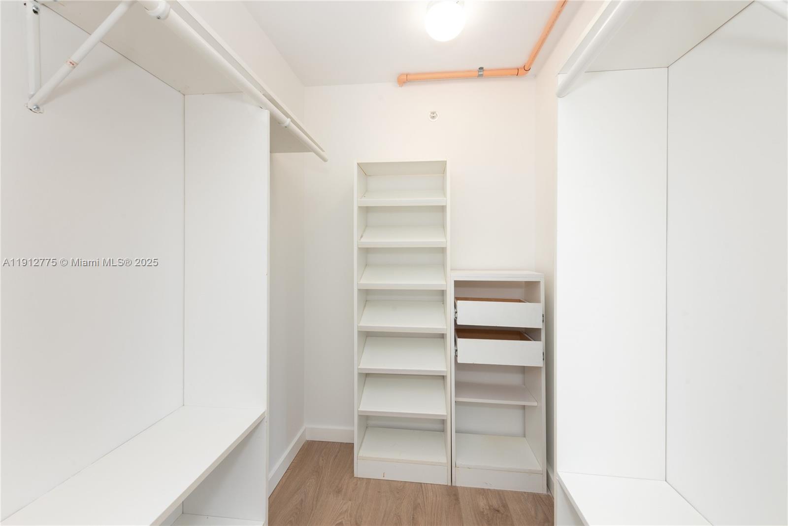 1881 Washington Avenue, Unit 3D Miami Beach, FL 33139 - Photo 14 of 30 a view of walk in closet with empty racks