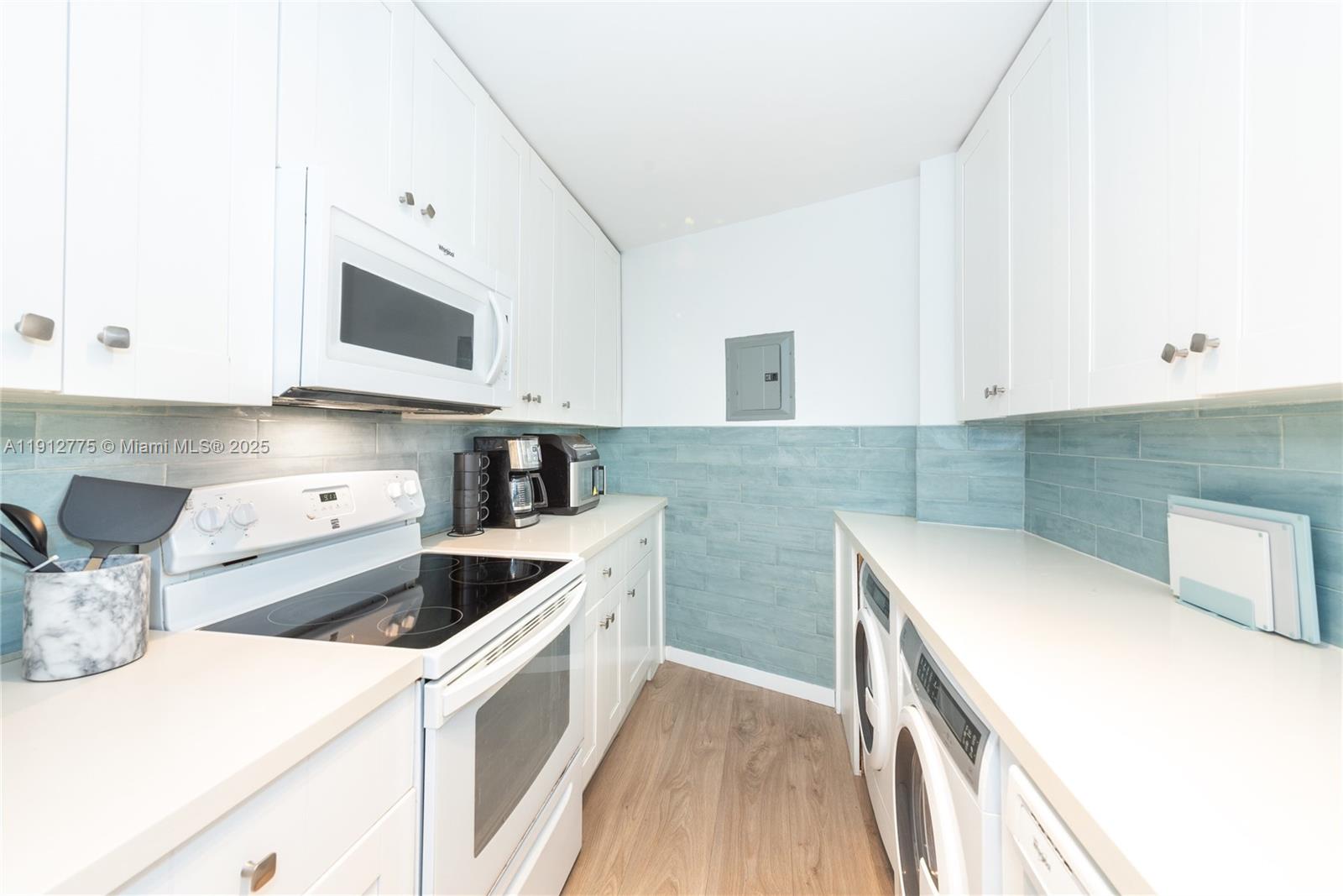 1881 Washington Avenue, Unit 3D Miami Beach, FL 33139 - Photo 16 of 30 a kitchen with stainless steel appliances granite countertop a sink and a stove
