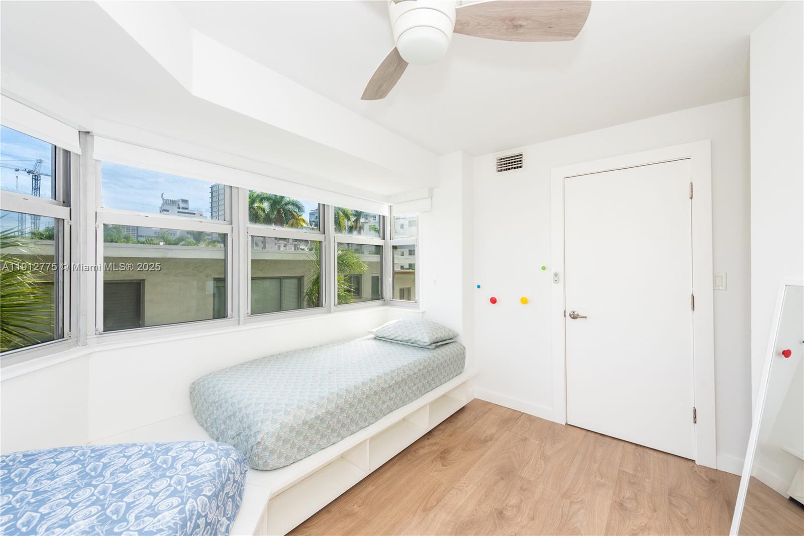 1881 Washington Avenue, Unit 3D Miami Beach, FL 33139 - Photo 19 of 30 a large bedroom with a bed and a large window
