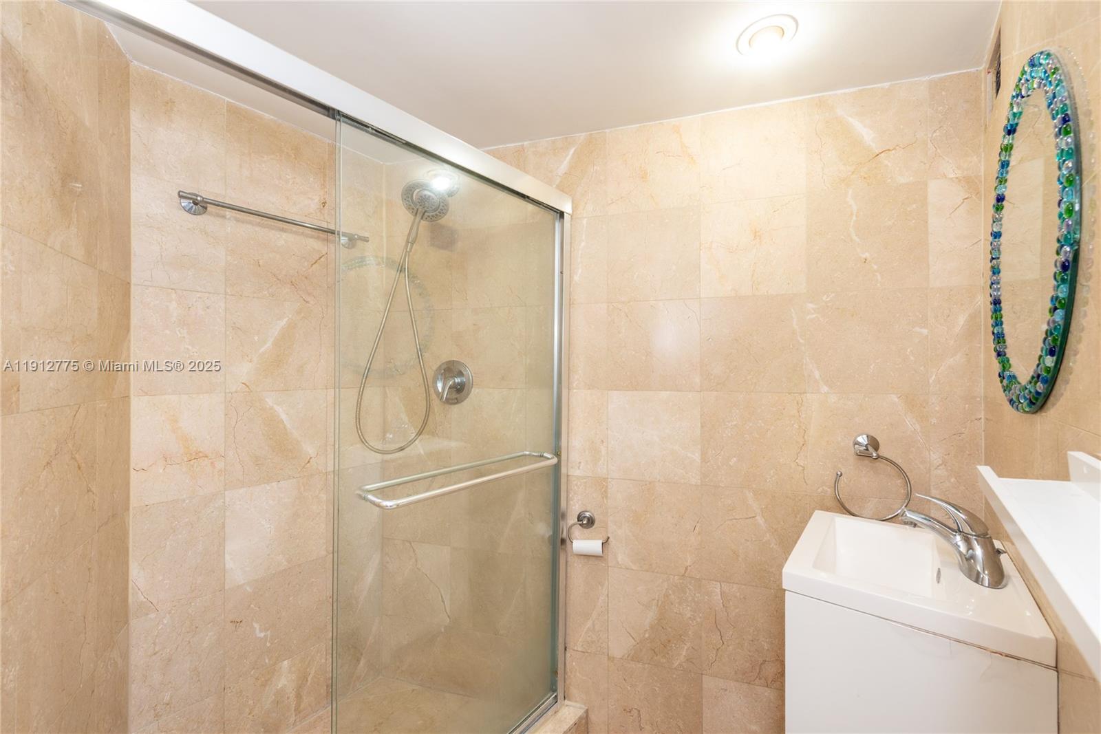 1881 Washington Avenue, Unit 3D Miami Beach, FL 33139 - Photo 21 of 30 a bathroom with a shower and a sink