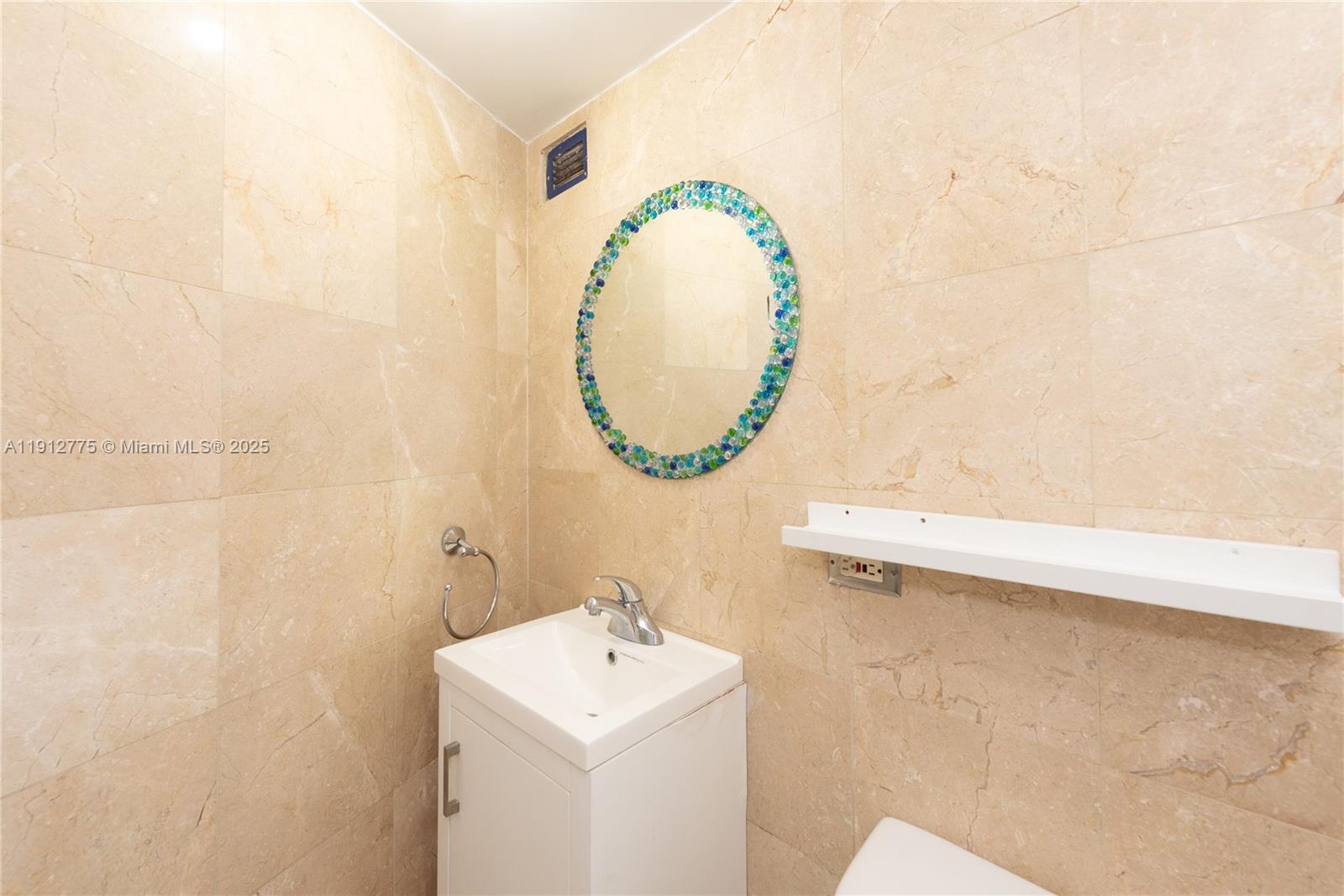1881 Washington Avenue, Unit 3D Miami Beach, FL 33139 - Photo 22 of 30 a bathroom with a sink and a mirror