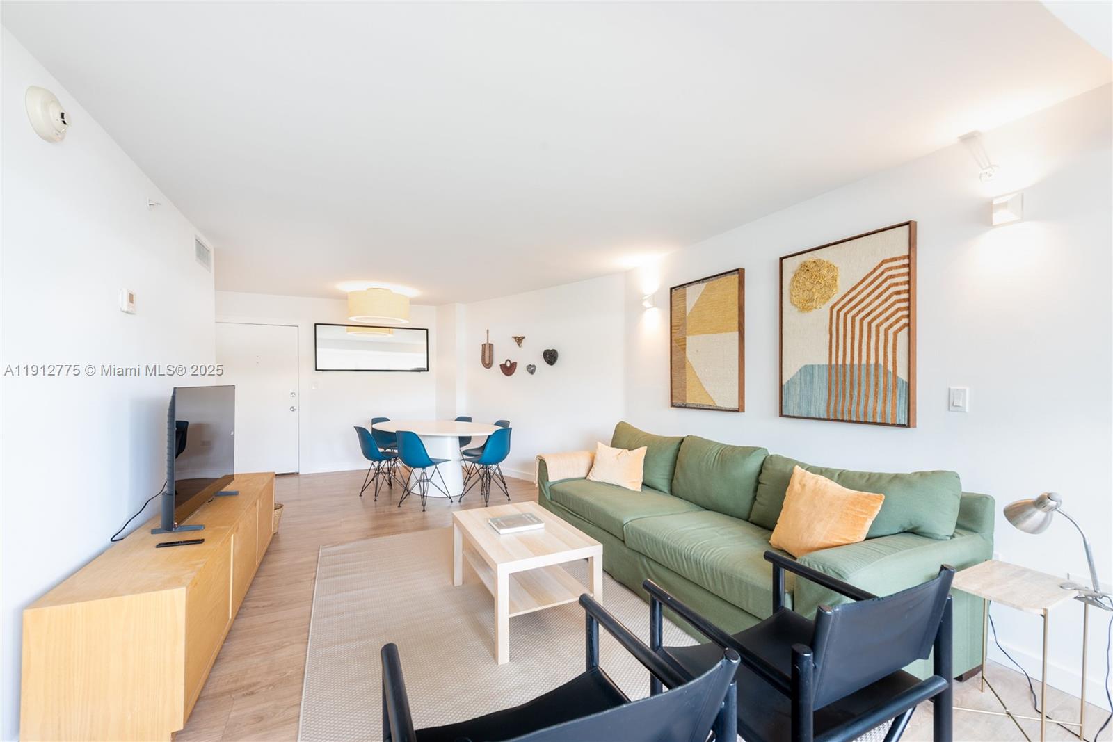 1881 Washington Avenue, Unit 3D Miami Beach, FL 33139 - Photo 4 of 30 a living room with furniture and a flat screen tv