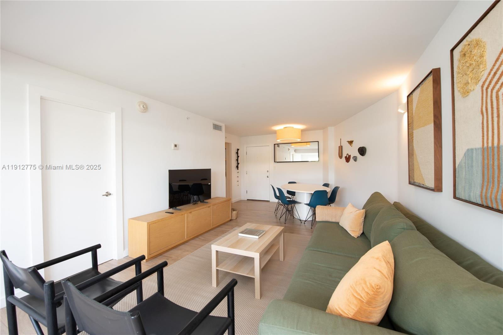 1881 Washington Avenue, Unit 3D Miami Beach, FL 33139 - Photo 5 of 30 a living room with furniture and a flat screen tv