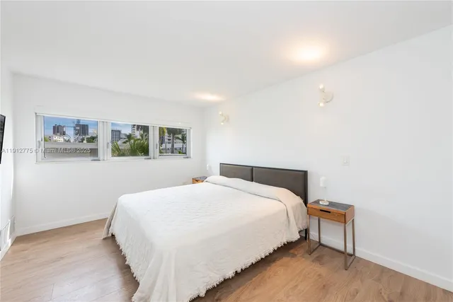 a bedroom with a bed and a wall painting