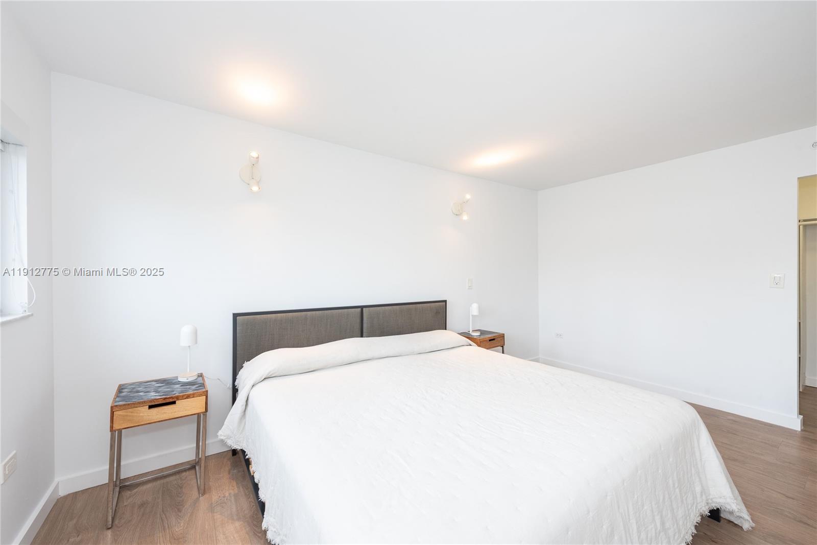 1881 Washington Avenue, Unit 3D Miami Beach, FL 33139 - Photo 9 of 30 a large bed sitting in a bedroom and table