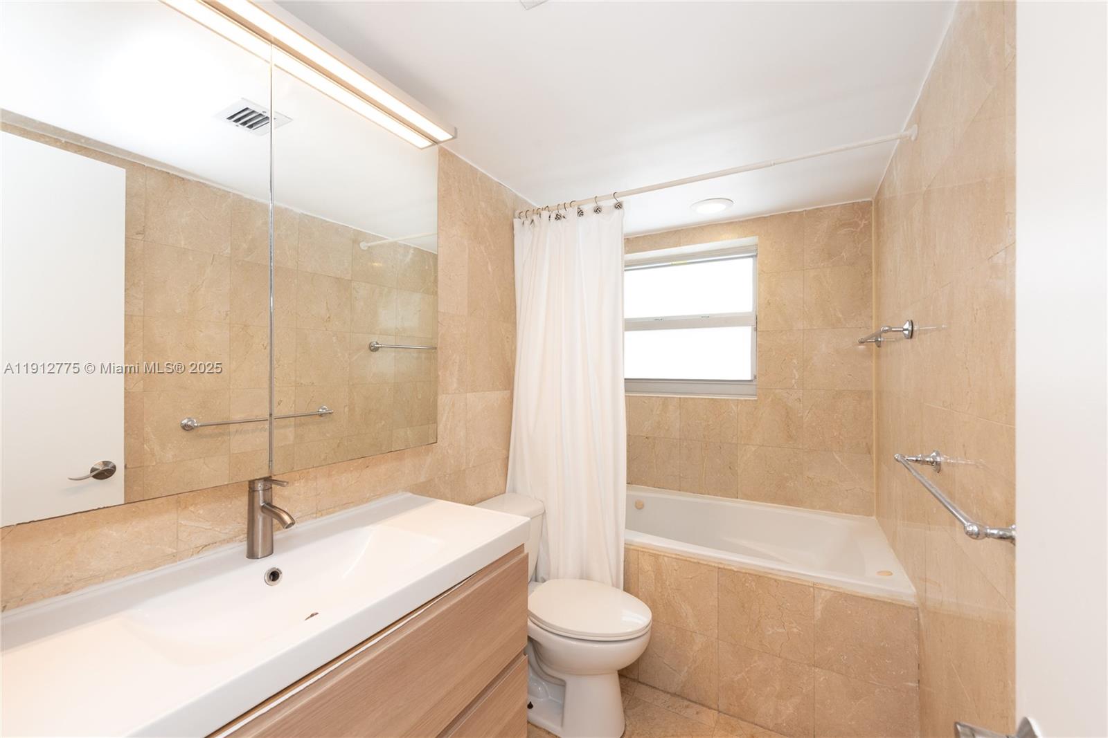 1881 Washington Avenue, Unit 3D Miami Beach, FL 33139 - Photo 10 of 30 a bathroom with a sink toilet and shower