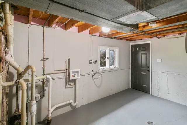 a view of an empty room with chandelier