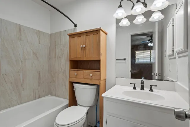 a bathroom with a sink a mirror and a toilet