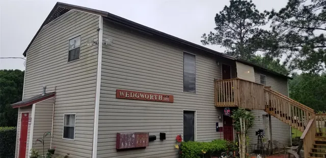 a kitchen with a sink a stove and white cabinets