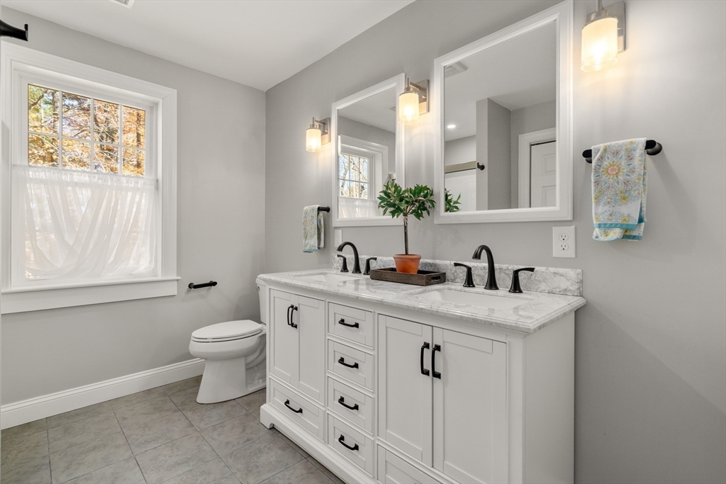 28 Allen Road Sturbridge, MA 01566 - Photo 19 of 33 a bathroom with double sink a toilet and a window