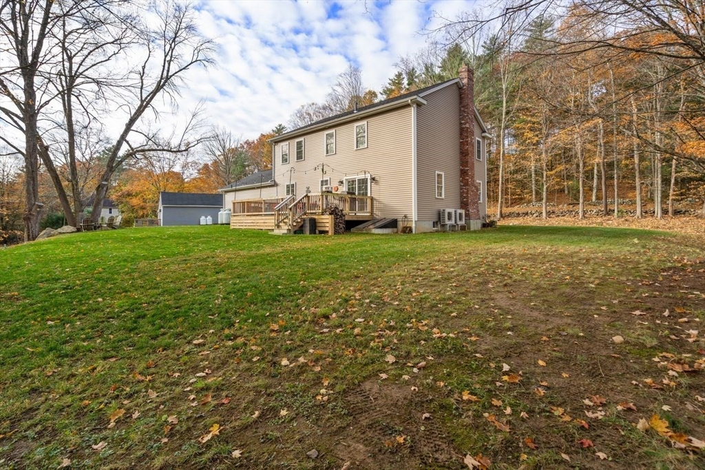 28 Allen Road Sturbridge, MA 01566 - Photo 28 of 33 a backyard of a house with table and chairs