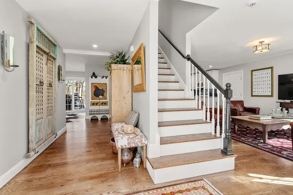 a view of entryway and hall with wooden floor