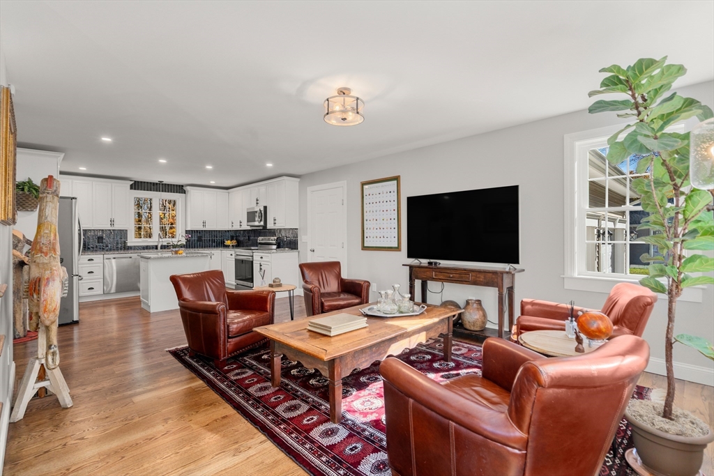 28 Allen Road Sturbridge, MA 01566 - Photo 4 of 33 a living room with furniture a flat screen tv and a dining table