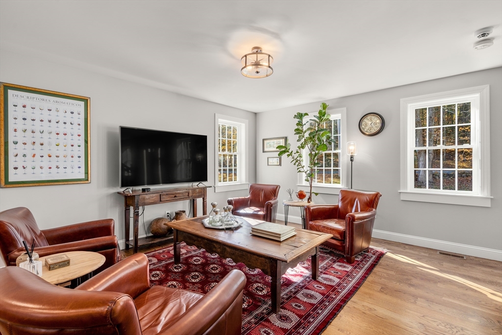 28 Allen Road Sturbridge, MA 01566 - Photo 5 of 33 a living room with furniture a flat screen tv and a window