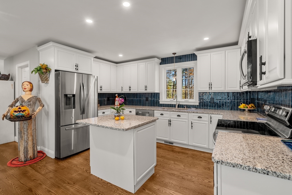 28 Allen Road Sturbridge, MA 01566 - Photo 8 of 33 a kitchen with a refrigerator sink and cabinets