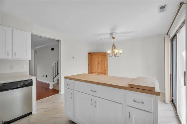 a spacious bathroom with a granite countertop sink and a mirror