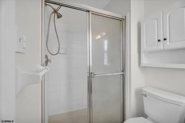 a bathroom that has a glass shower door