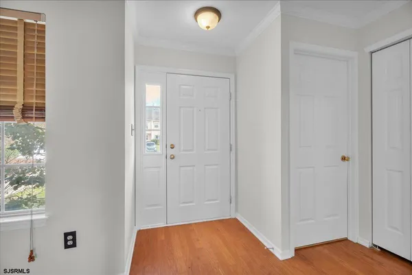 a view of a room with wooden floor and windows
