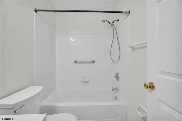a bathroom with a bath tub with a shower