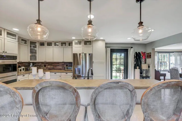 a open kitchen with stainless steel appliances granite countertop a lot of counter space and wooden floors