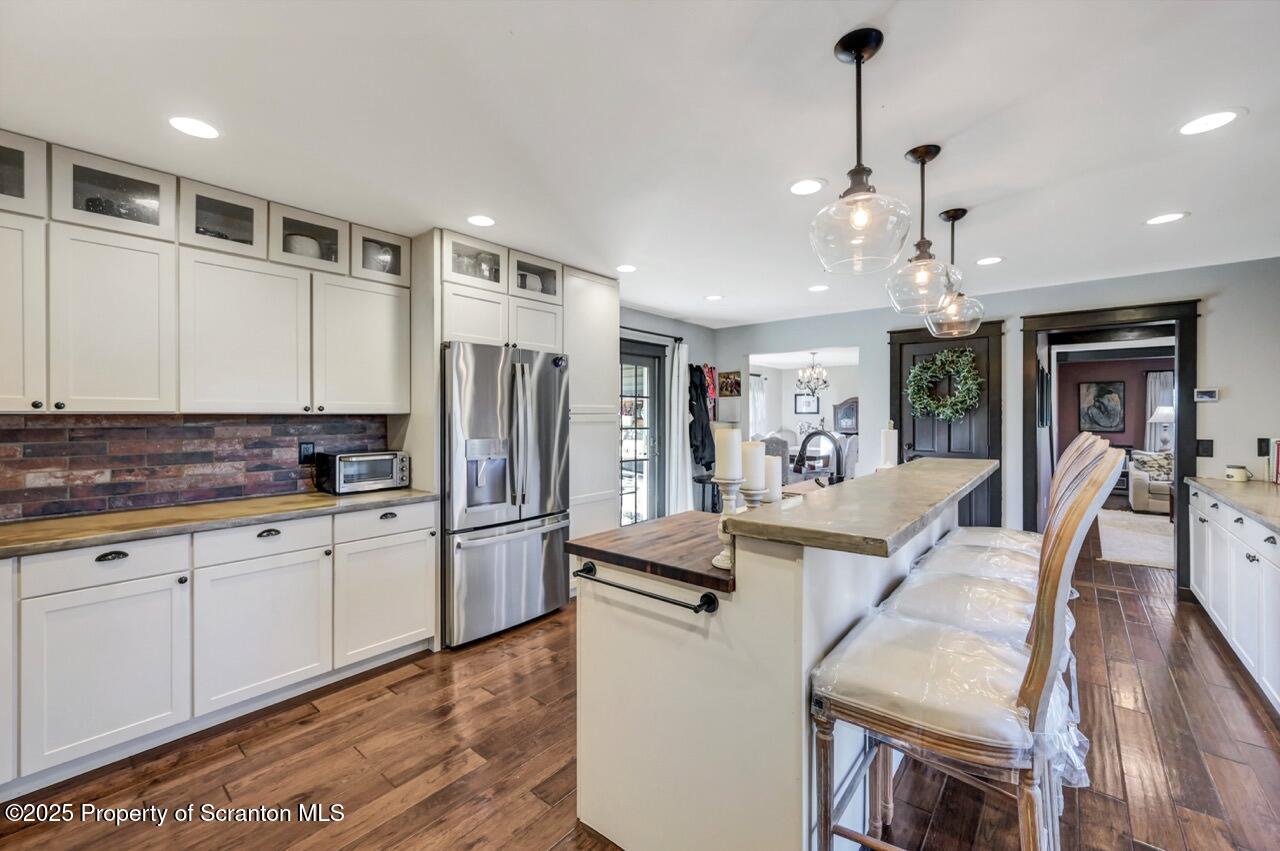 2225 Cherry Hill Road Clarks Summit, PA 18411 - Photo 13 of 81 a large kitchen with stainless steel appliances granite countertop a refrigerator a oven a dining table and chairs with wooden floor