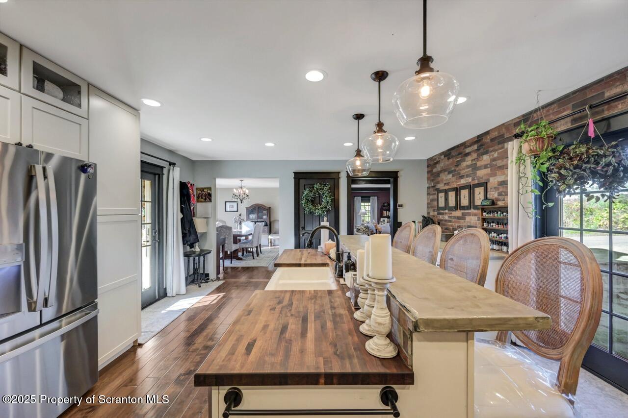 2225 Cherry Hill Road Clarks Summit, PA 18411 - Photo 14 of 81 a view of a dining room with furniture a chandelier and wooden floor